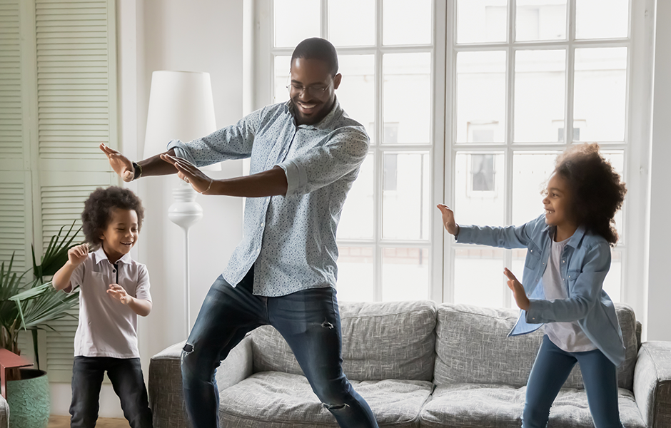 Family dancing together in living room
