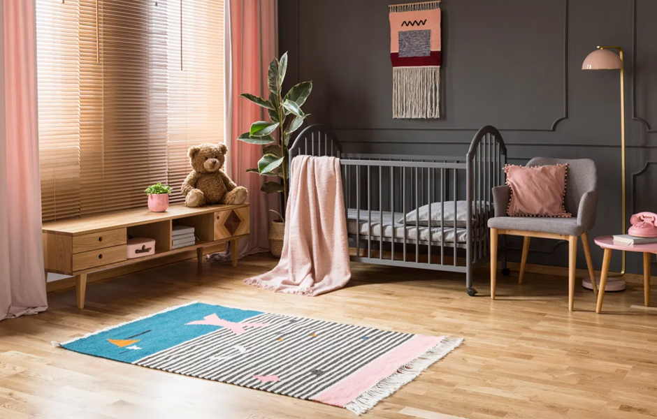 Striped rug in pink and grey nursery