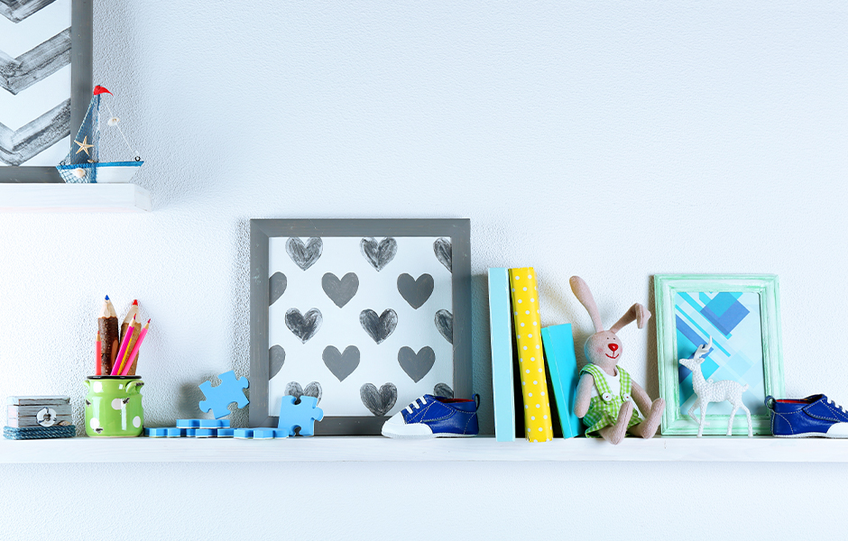 Baby books and toys on shelf